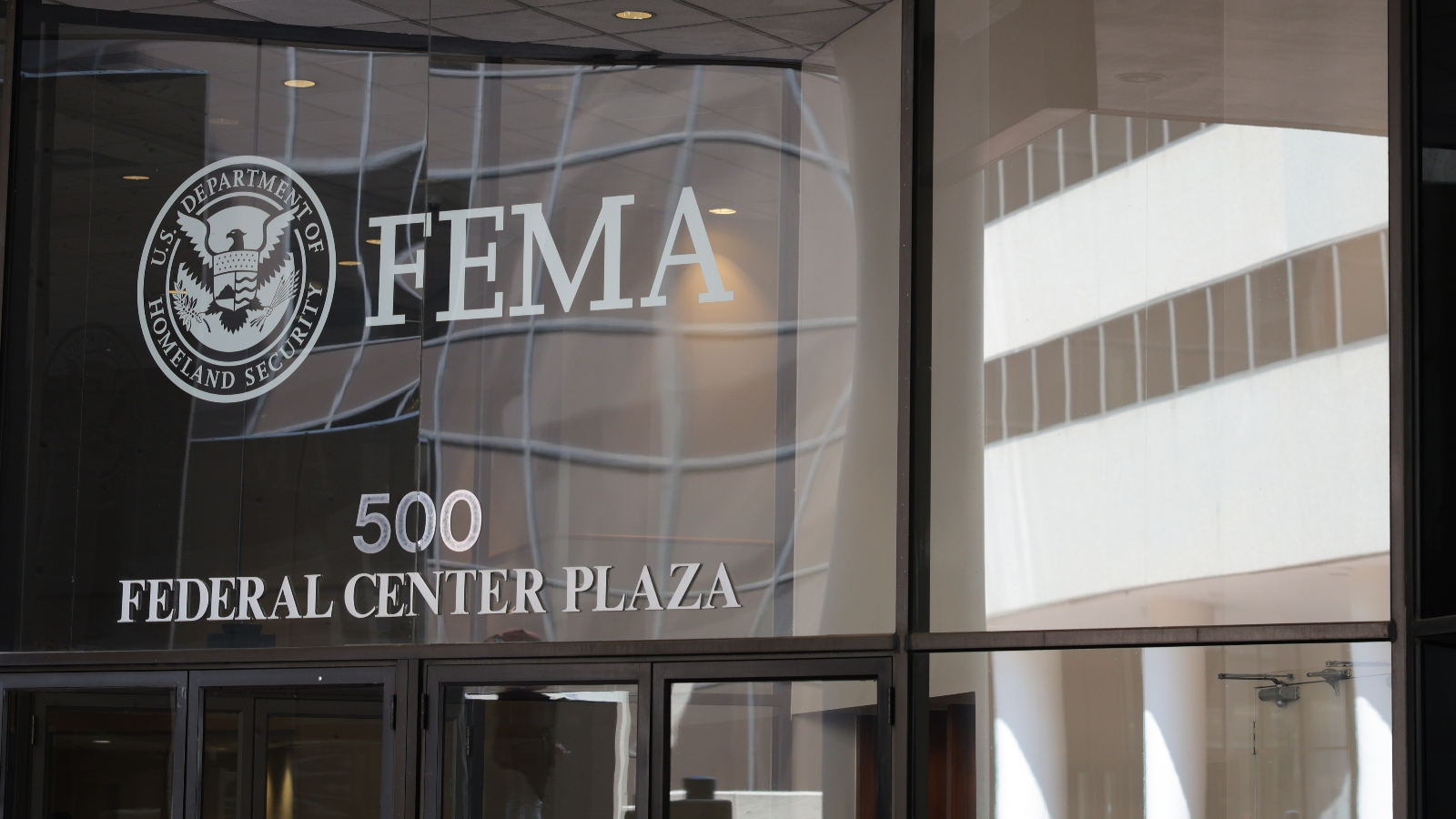 A photograph of the glass-paneled headquarters of FEMA.