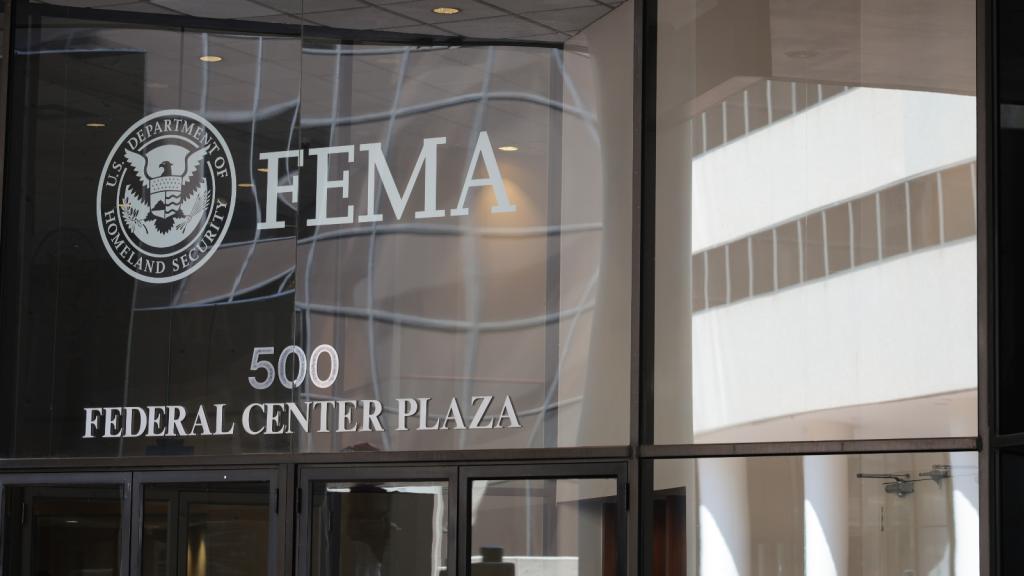 A photograph of the glass-paneled headquarters of FEMA.