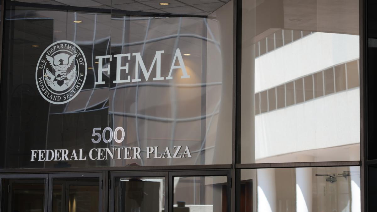 A photograph of the glass-paneled headquarters of FEMA.