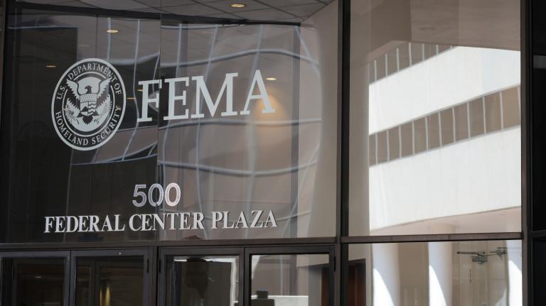 A photograph of the glass-paneled headquarters of FEMA.