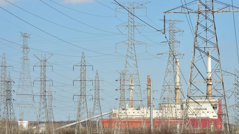 Electrical power lines running through Chicago with blue sky in the background