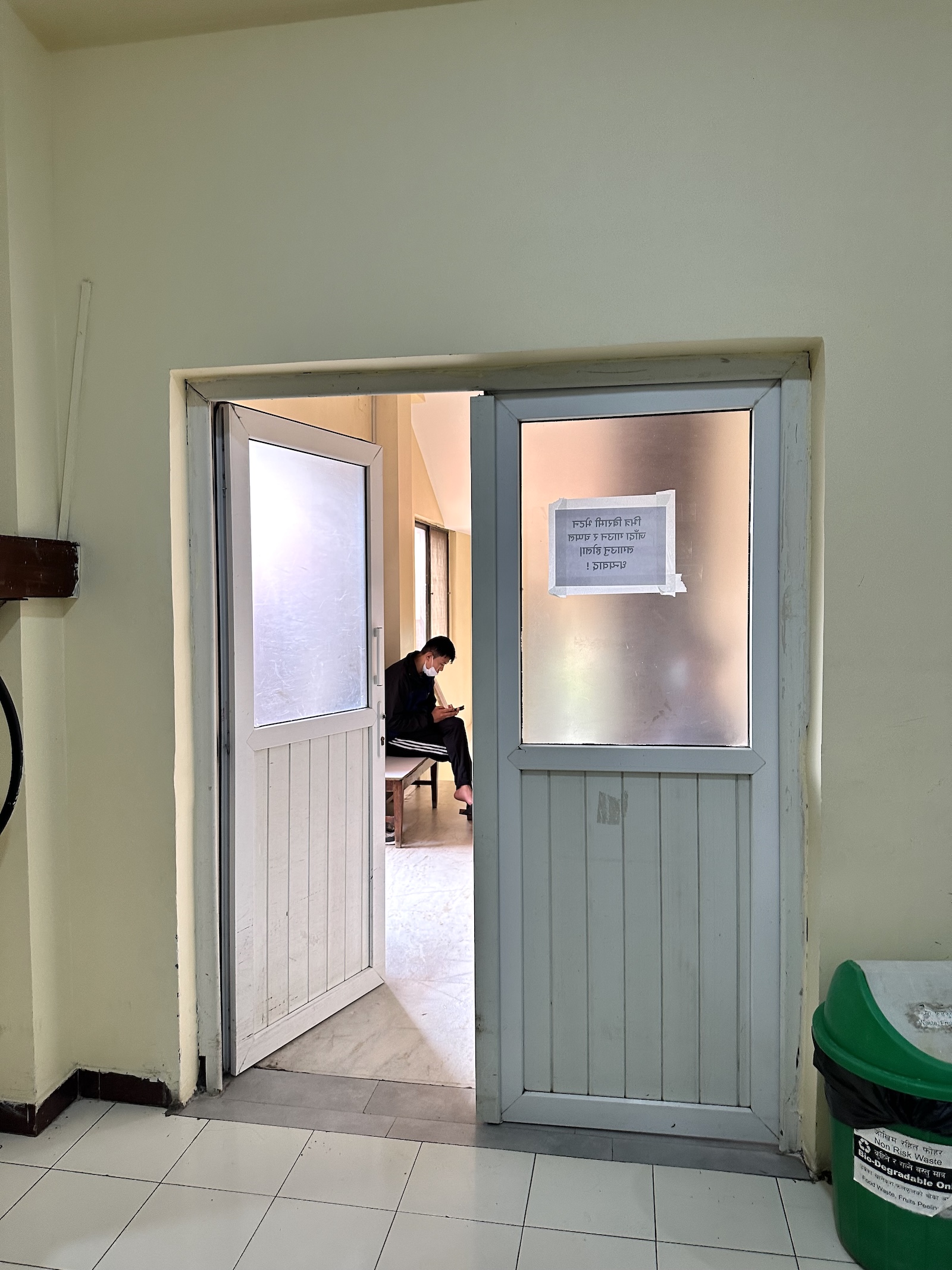 a man waits in a hospital waiting room