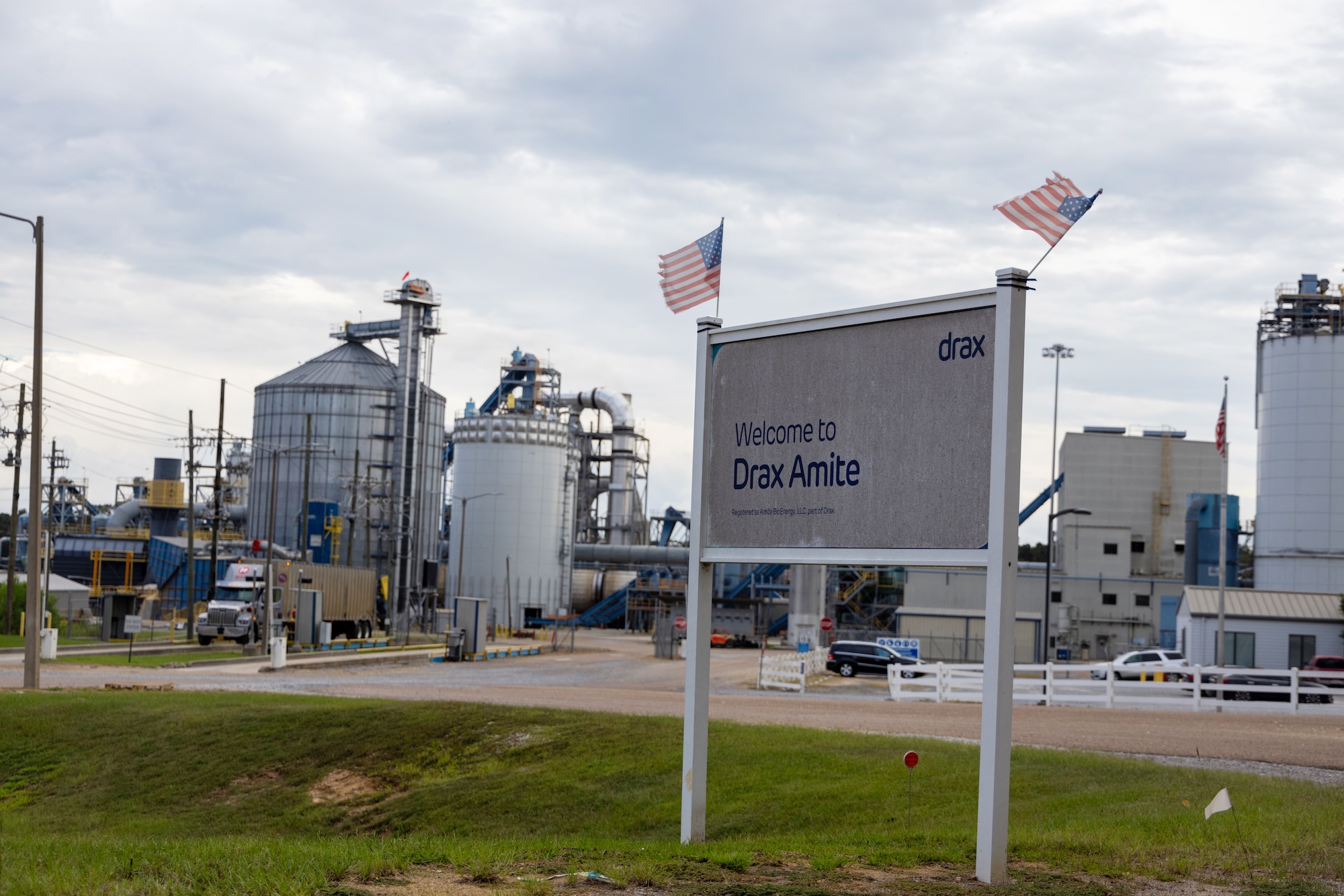 A sign outside a large industrial facility reads 'drax amite'