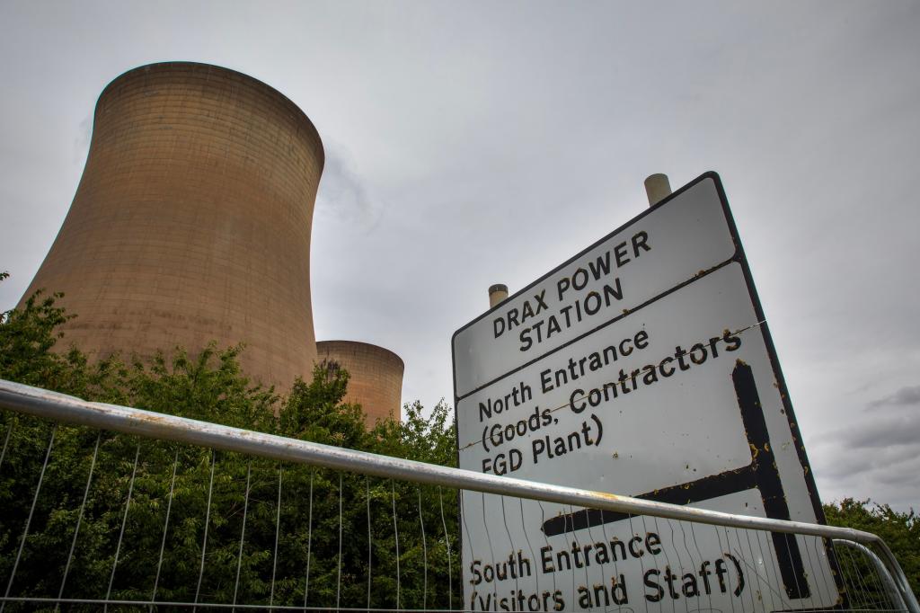 cooling towers near a sign for drax power station