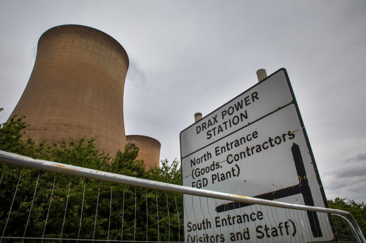 cooling towers near a sign for drax power station