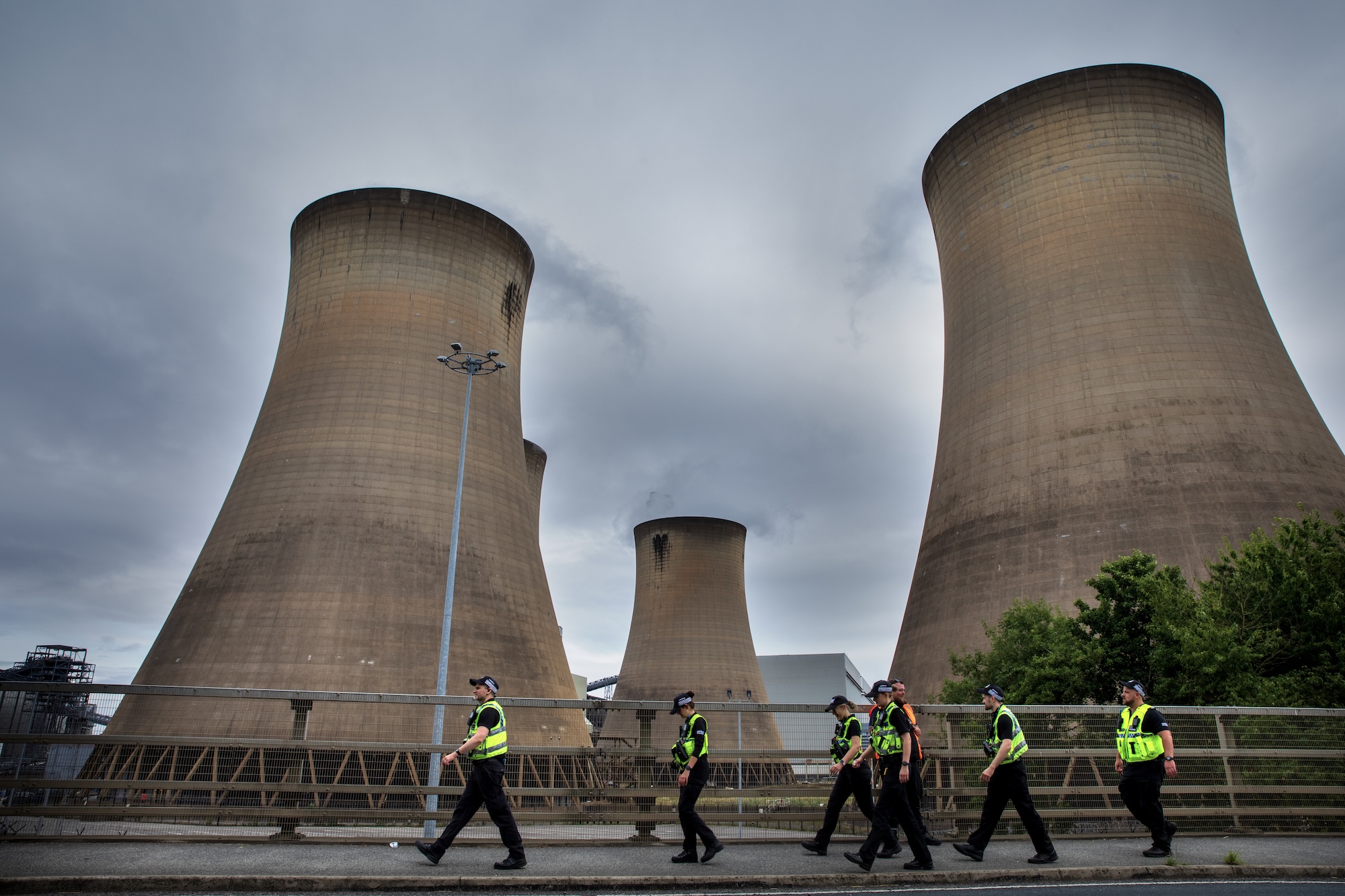 police march near cooling towers for drax power station