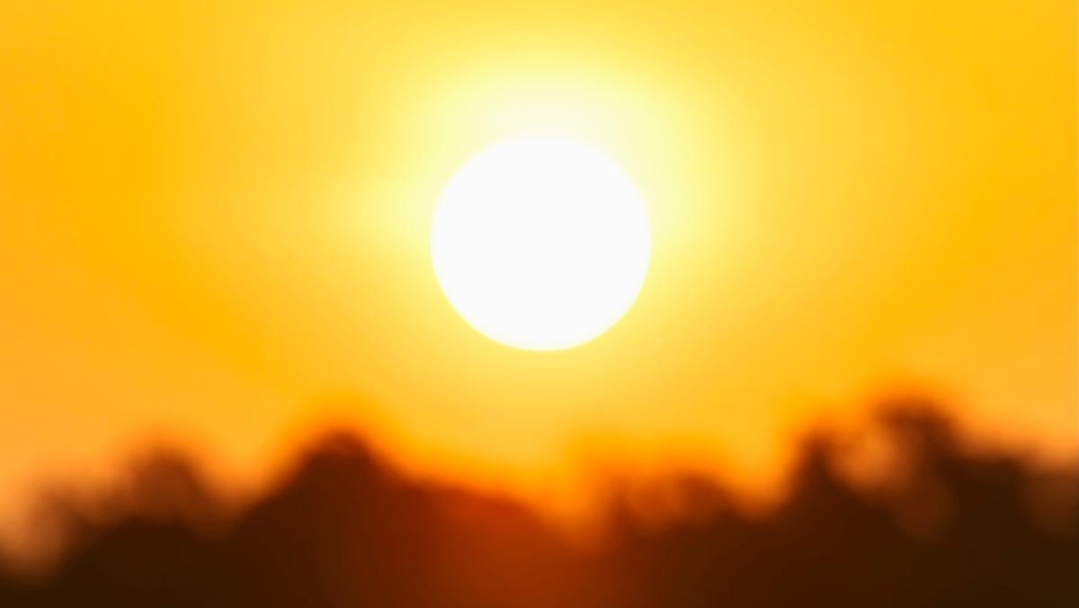 a hot sun with heat blur over a landscape also blurred