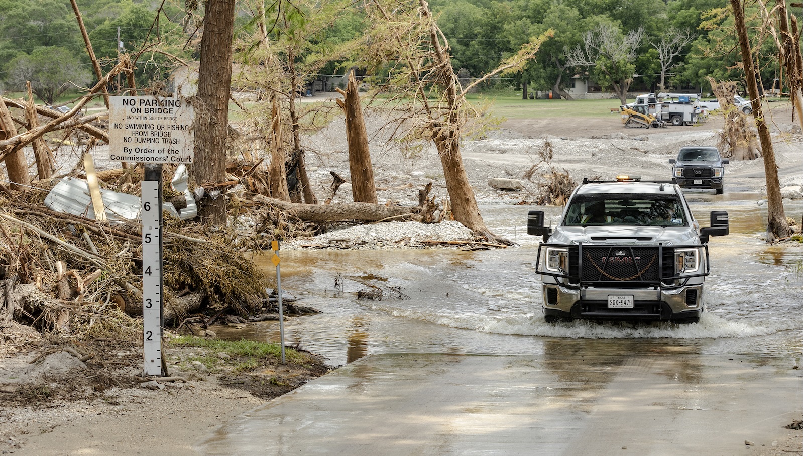 How the planet fared in 2025 — the good, the bad, and the ugly a truck drives though water on a flooded bridge