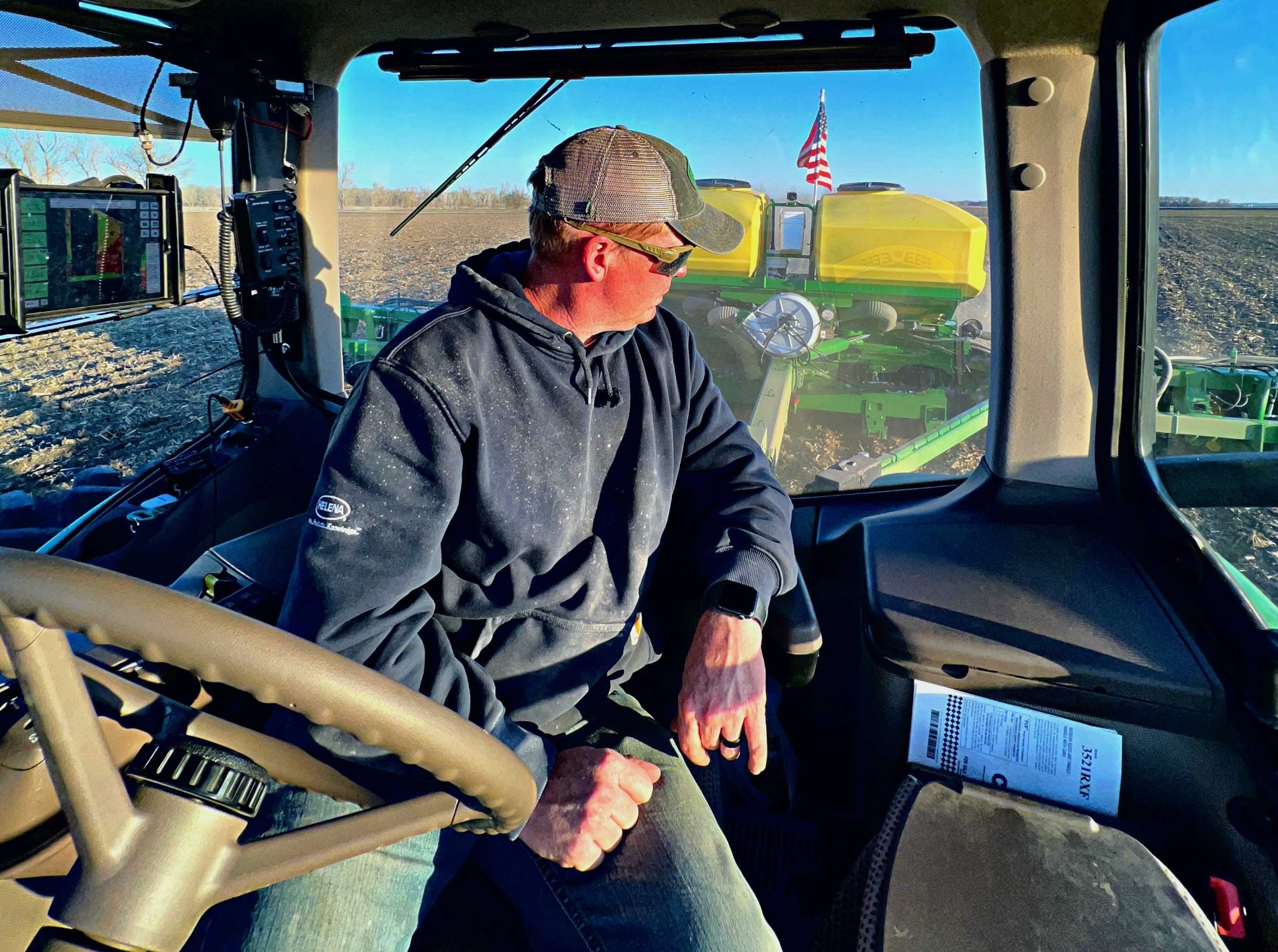 Quentin Connealy looks back at his crops from the seat of his tractor. Connealy, who has been farming full time for the past 15 years, said he has had to deal with increasingly extreme weather.