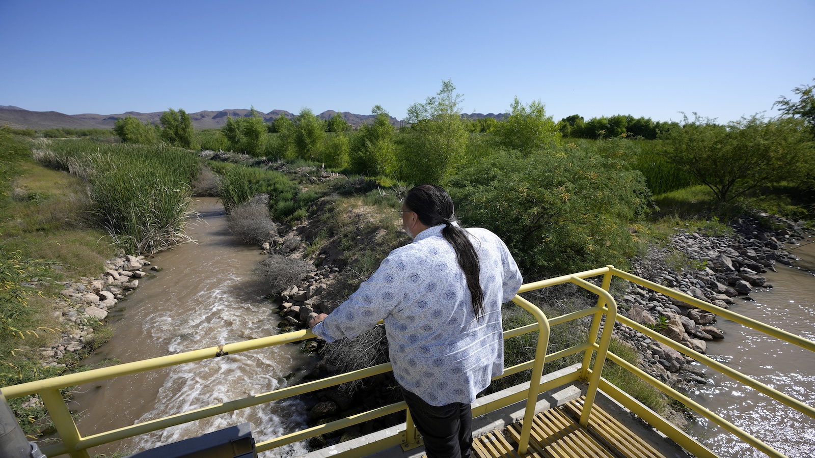 Man stands over river
