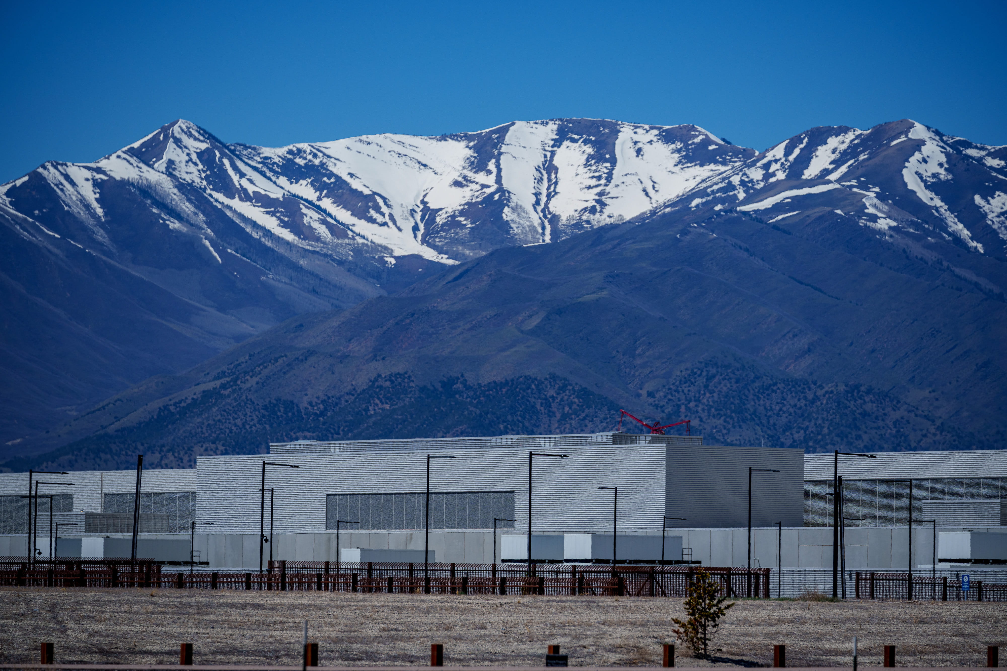 A snow-covered mountain range behind a data center