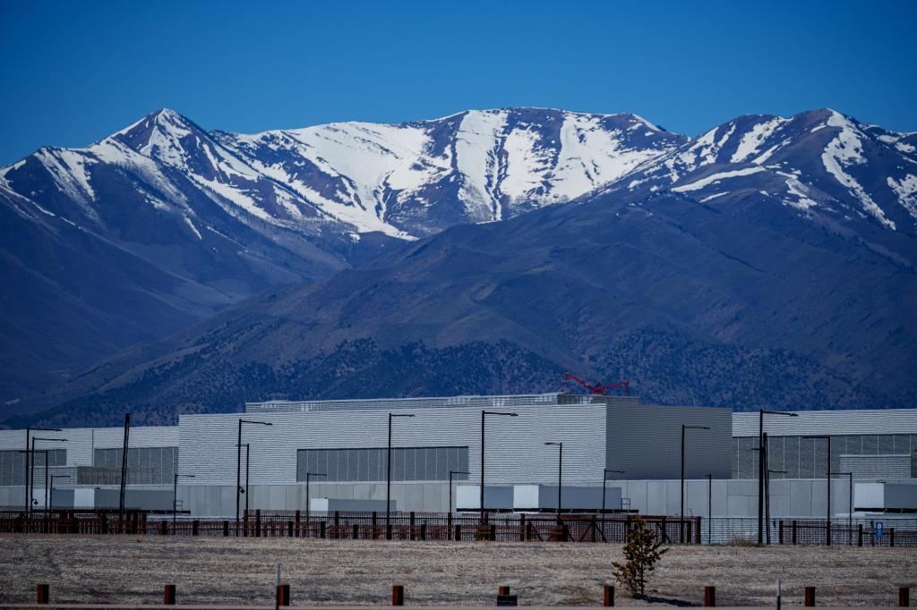 A snow-covered mountain range behind a data center