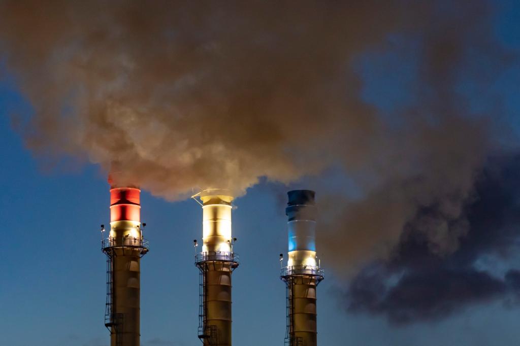 Red, white, and blue smokestacks at the Dearborn Industrial Generation facility are seen flaring gas into the atmosphere