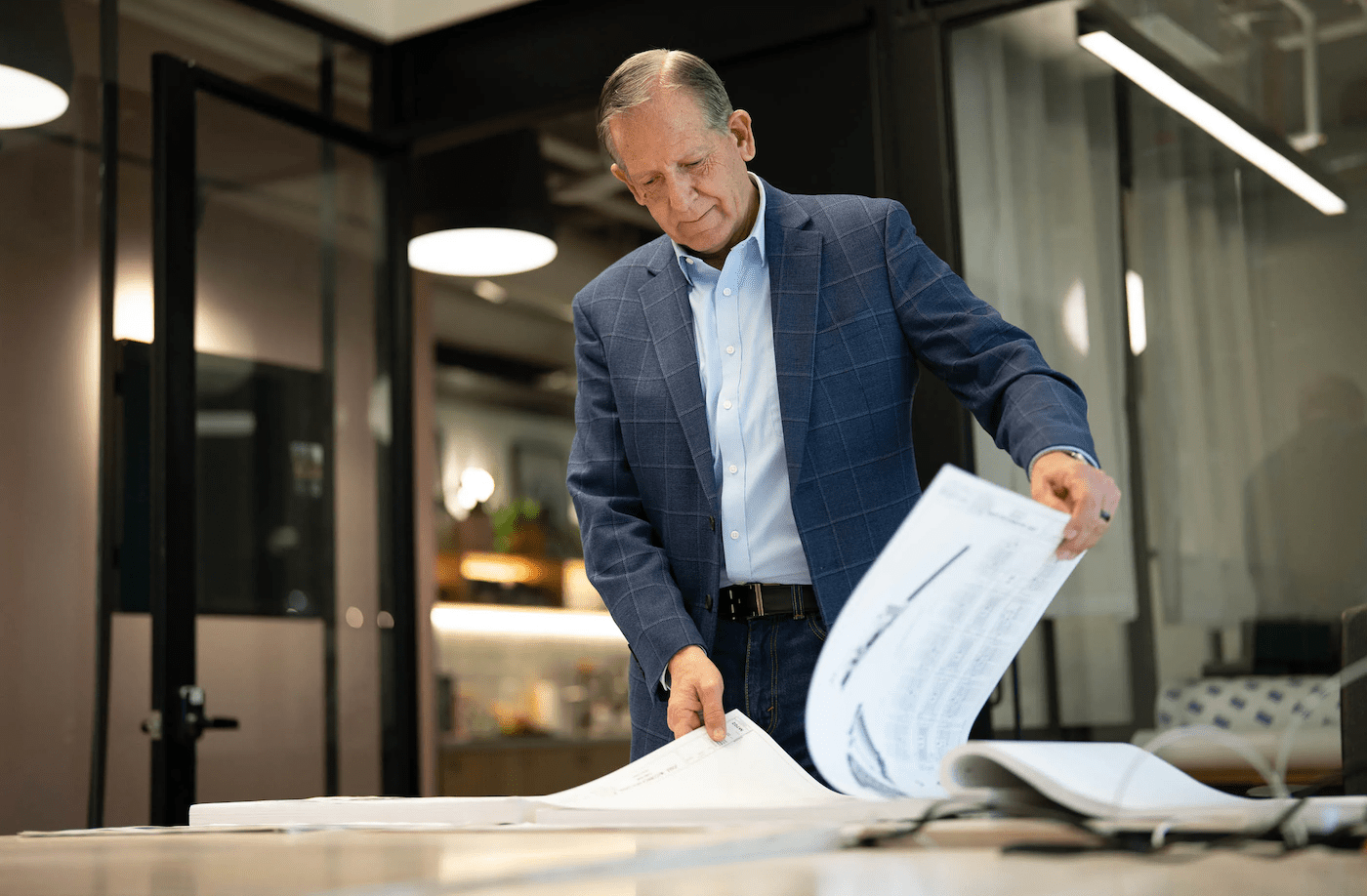 The landowner and executive behind a massive data center complex looks through the project's plans.