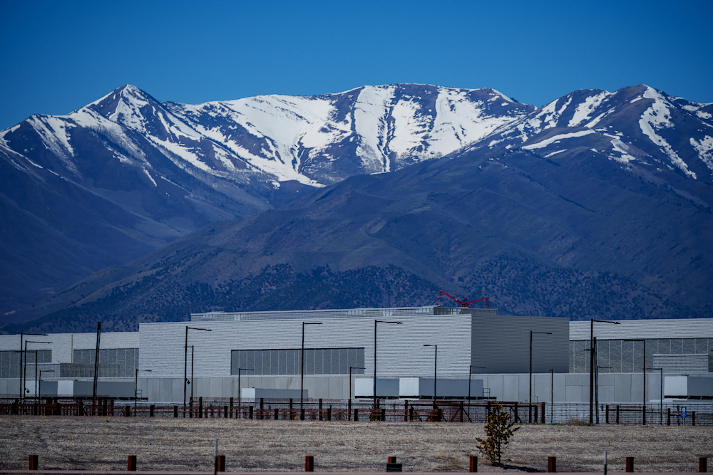A snow-covered mountain range behind a data center