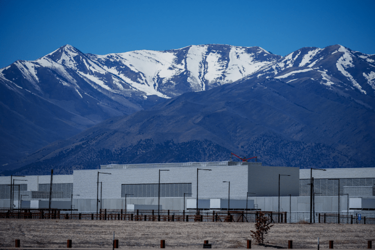 A snow-covered mountain range behind a data center