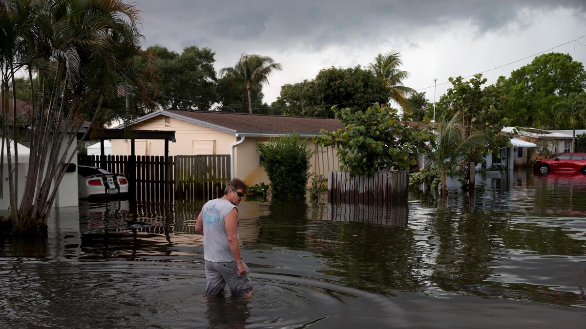 A person walks through a flooded street in Fort Lauderdale, Florida, in April of 2023, following a historic rainstorm. Florida has invested more than $1 billion in projects that adapt to flooding and sea level rise.