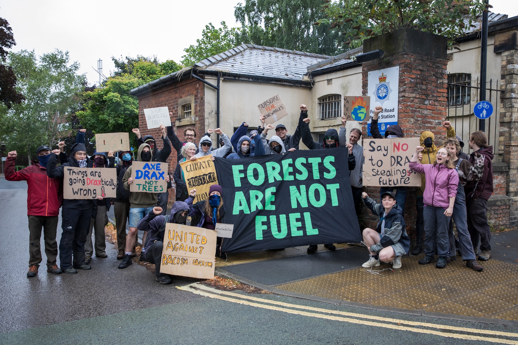protesters with signs against drax