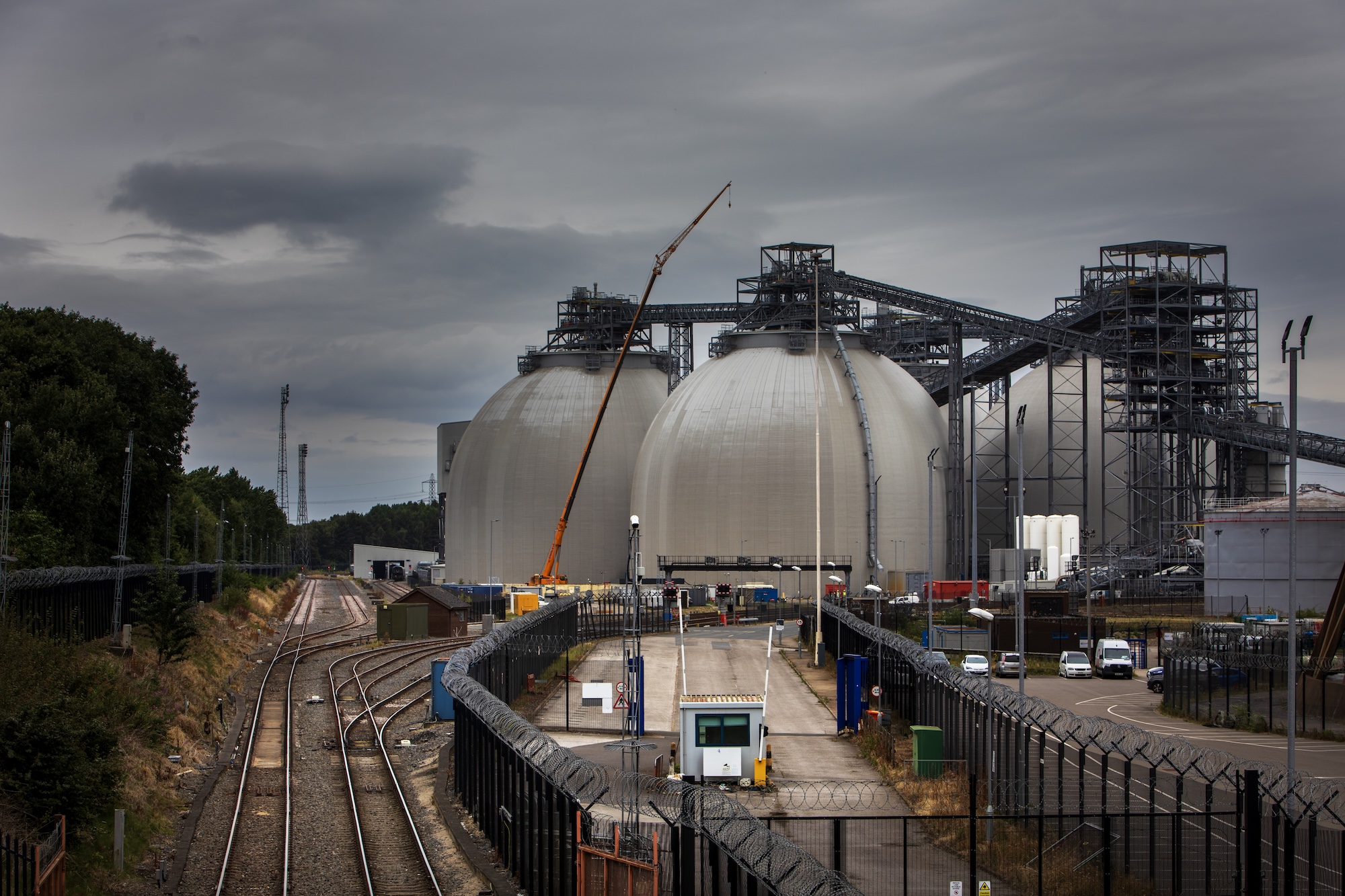 train tracks near giant storage domes
