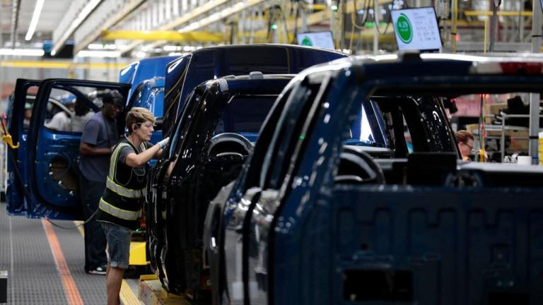 trucks lined up in a manufacturing plant