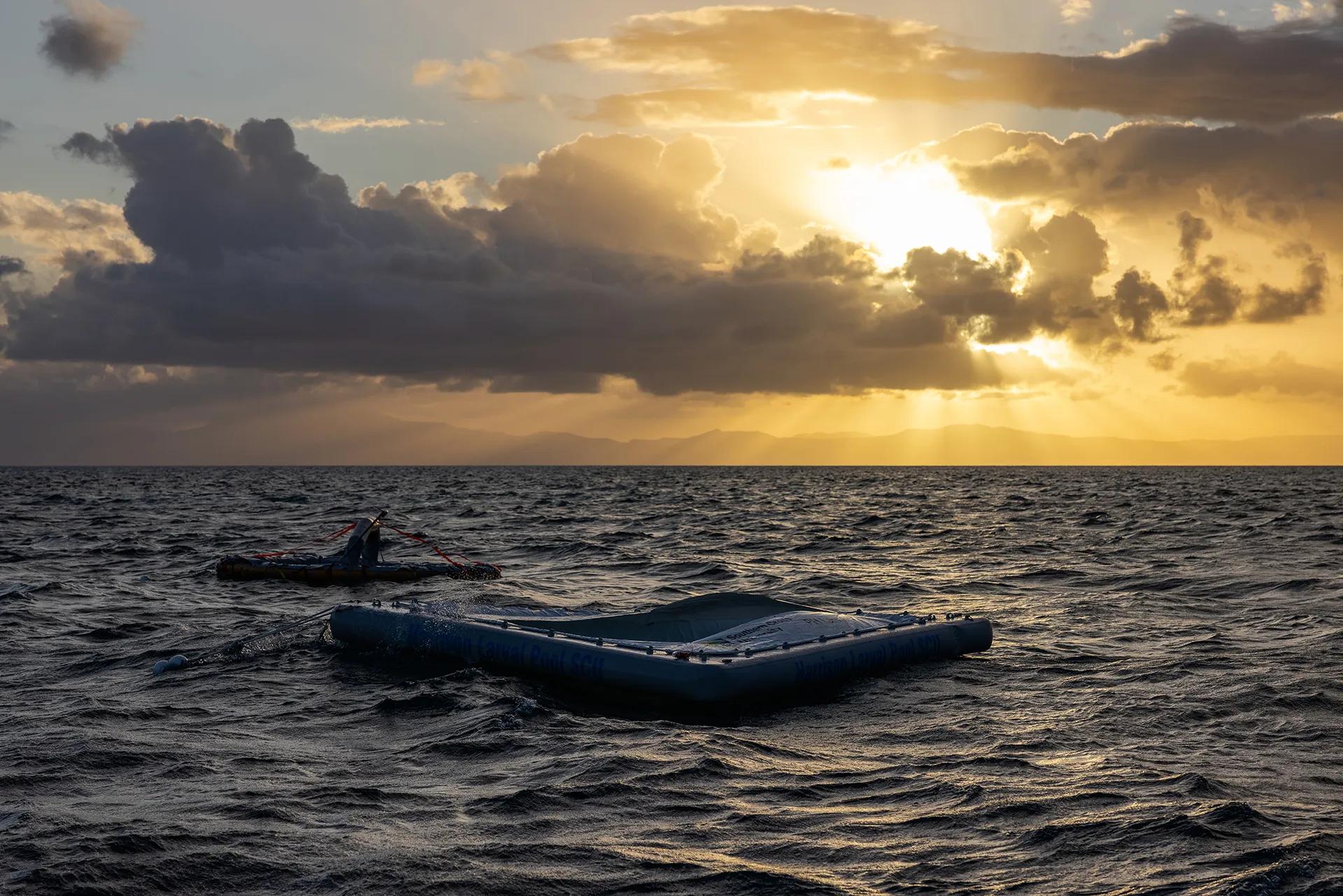 A raft floats on the water at sunset