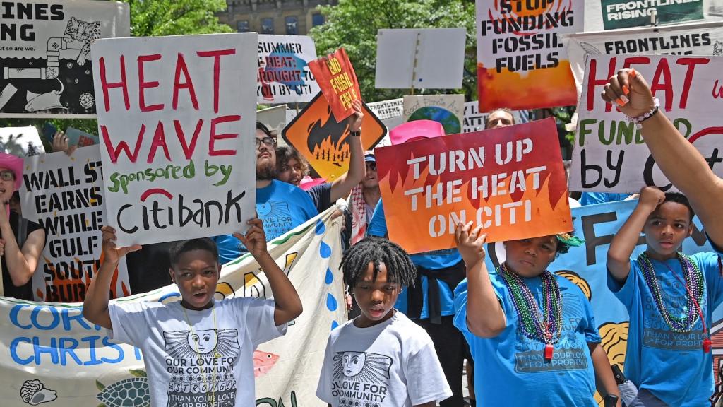 Environmental activists march in lower Manhattan, New York, to demand Wall Street stop funding of fossil fuel projects.