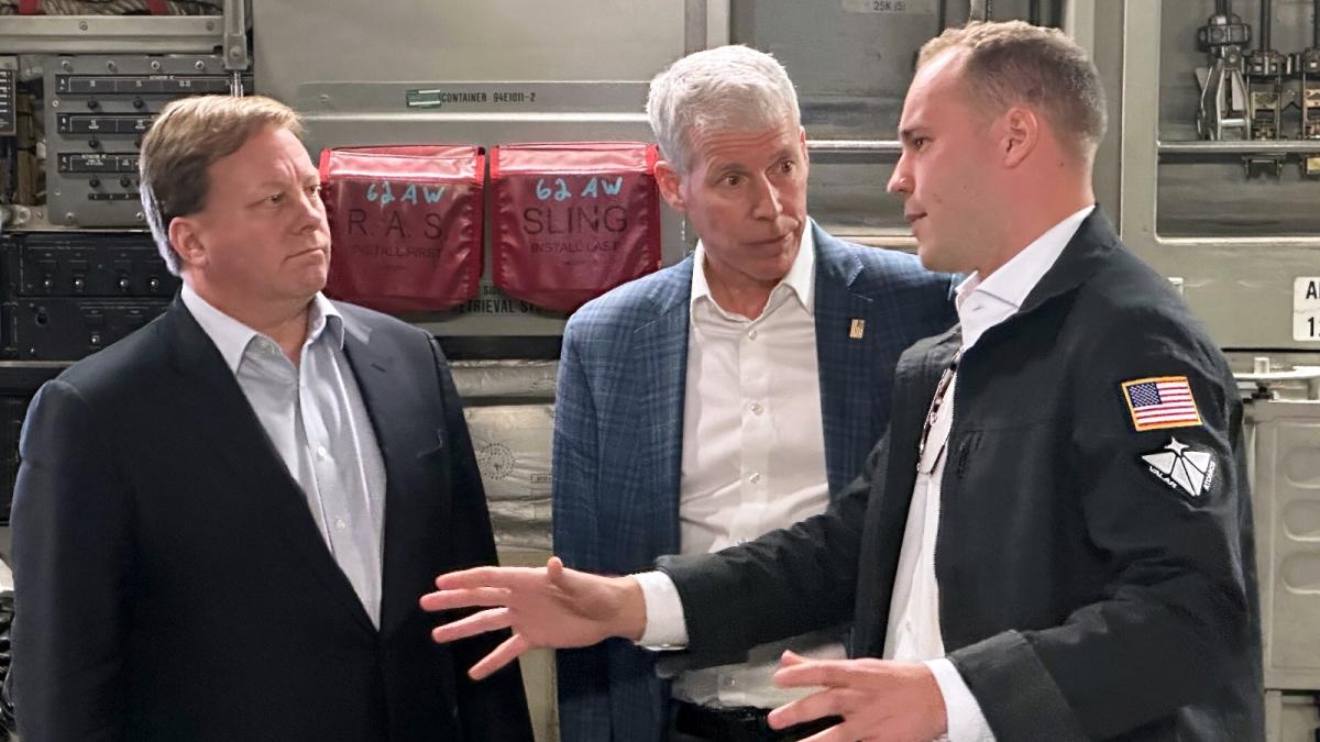 Three men in suits talk