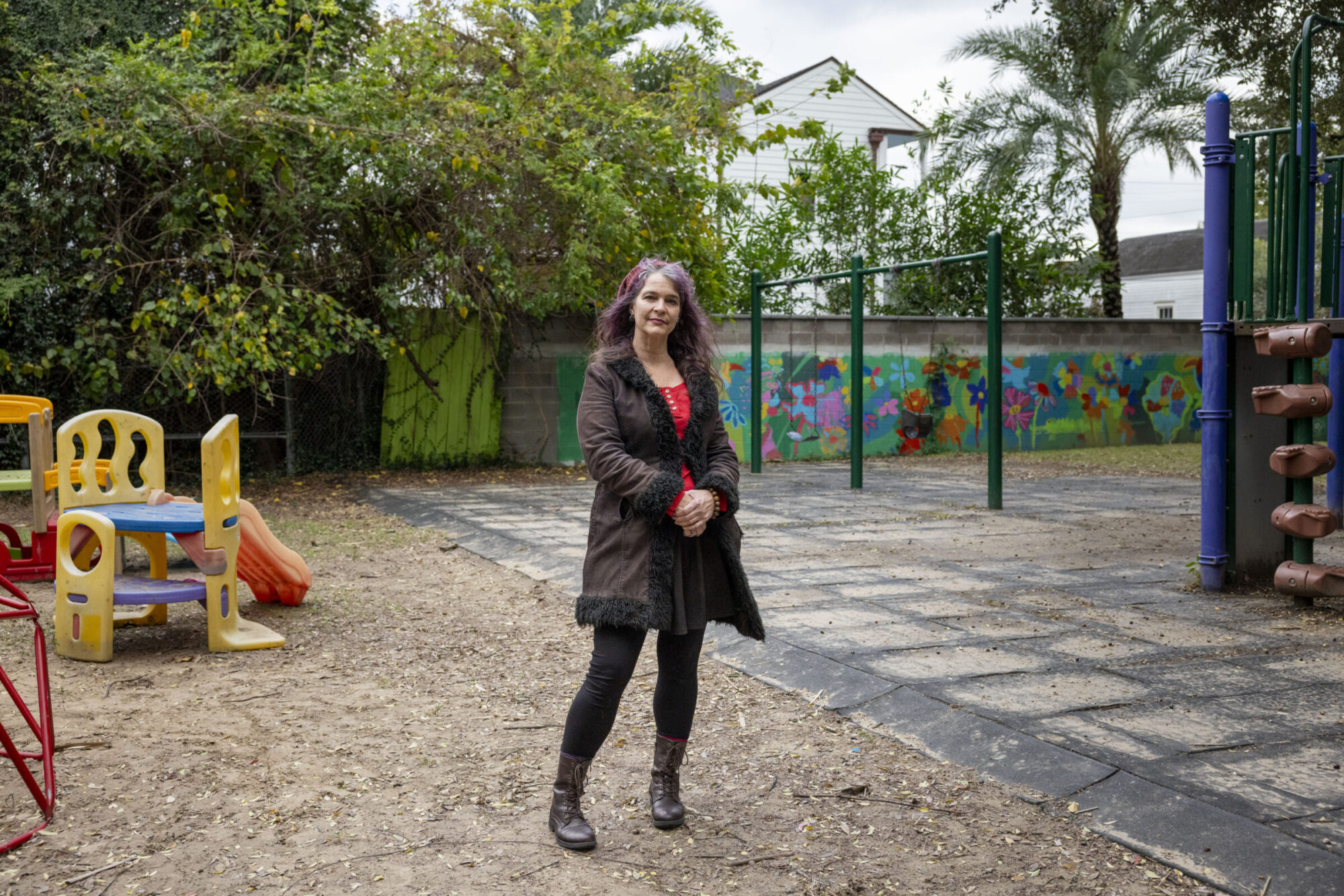 A woman stands in a playground