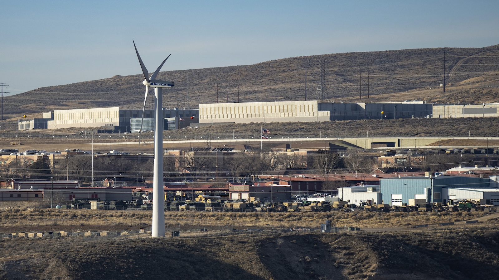 A picture of the National Security Agency's data facility with a wind turbine in the foreground