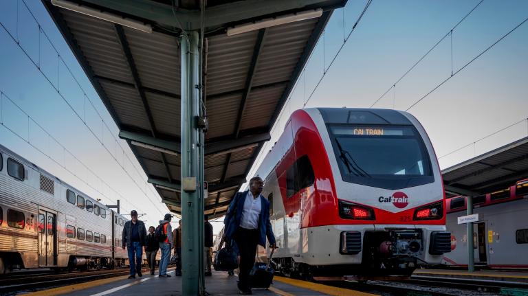 Passengers disembark from an electric Caltrain commuter train in the San Francisco Bay Area.