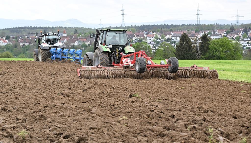 A tractor rolls over an agricultural field