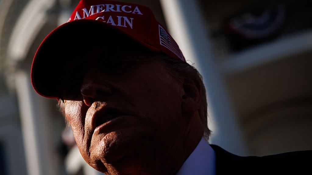 Close up of Donald Trump wearing a red Make America Great Again hat