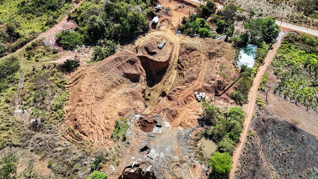 An overhead view of dug up dirt in the middle of a forest