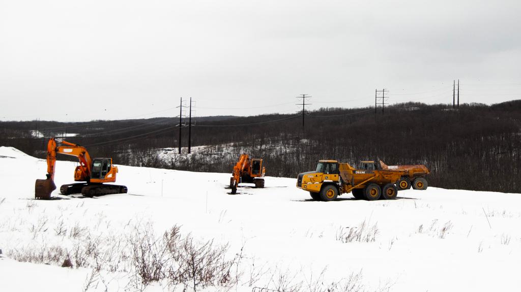 A high-voltage power line runs behind a snowy construction site in Archbald, Pennsylvania.