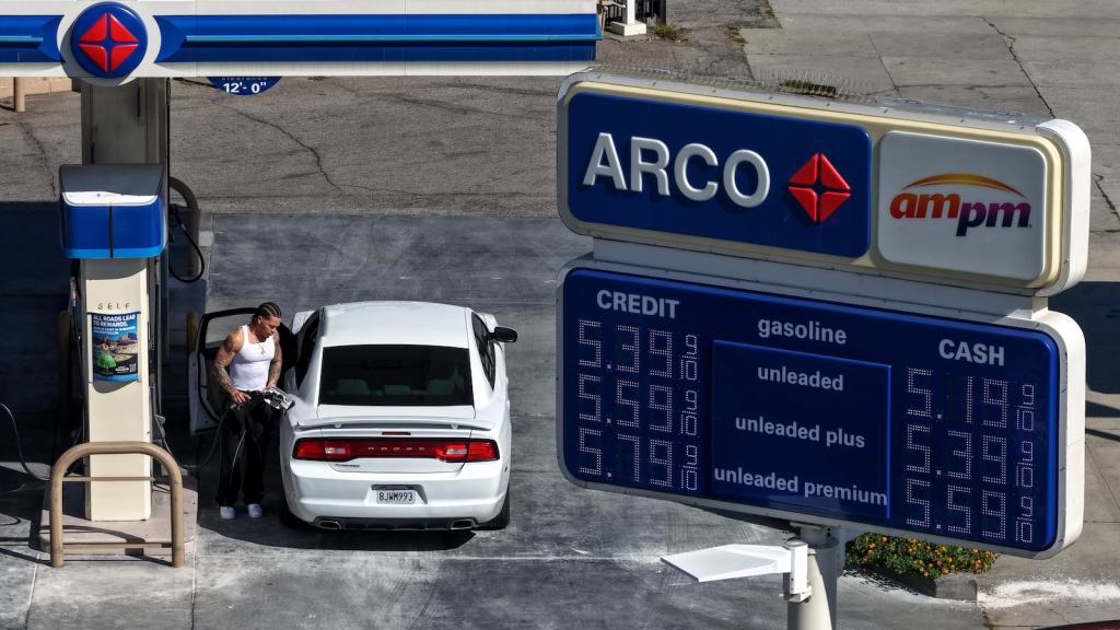 In an aerial view, a customer pumps gas into his car at an Arco station in Los Angeles.