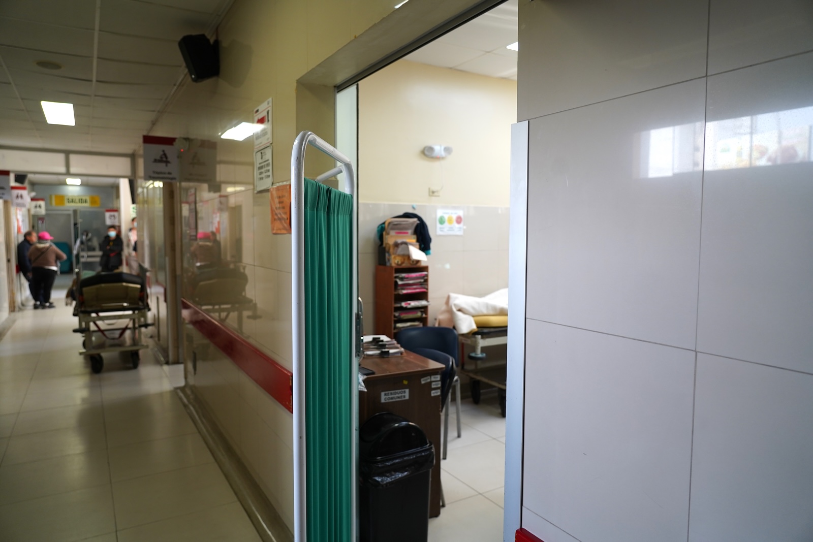 a green privacy screen over a door in a hospital room
