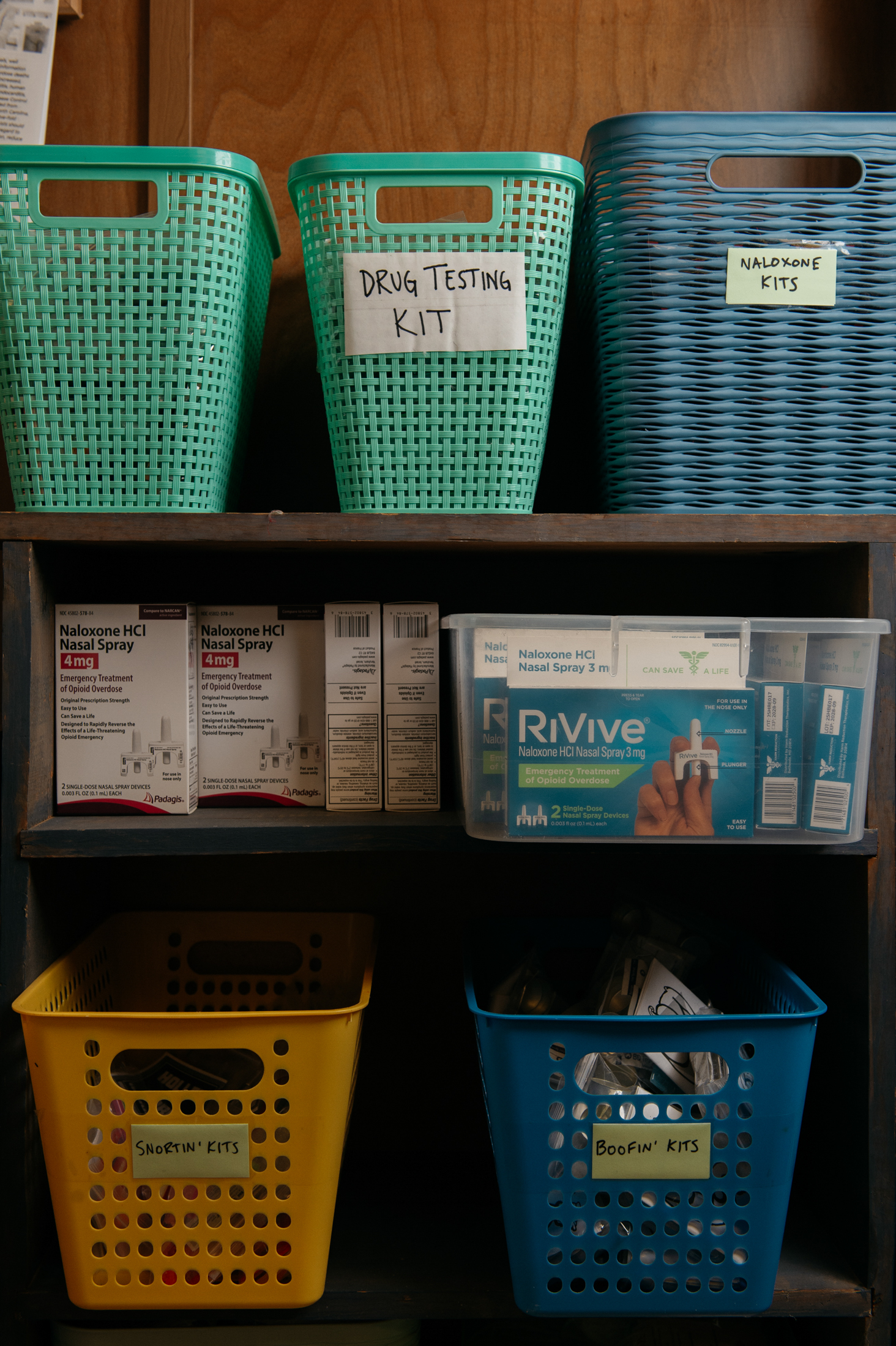 Storage bins sit on a shelf, labelled 