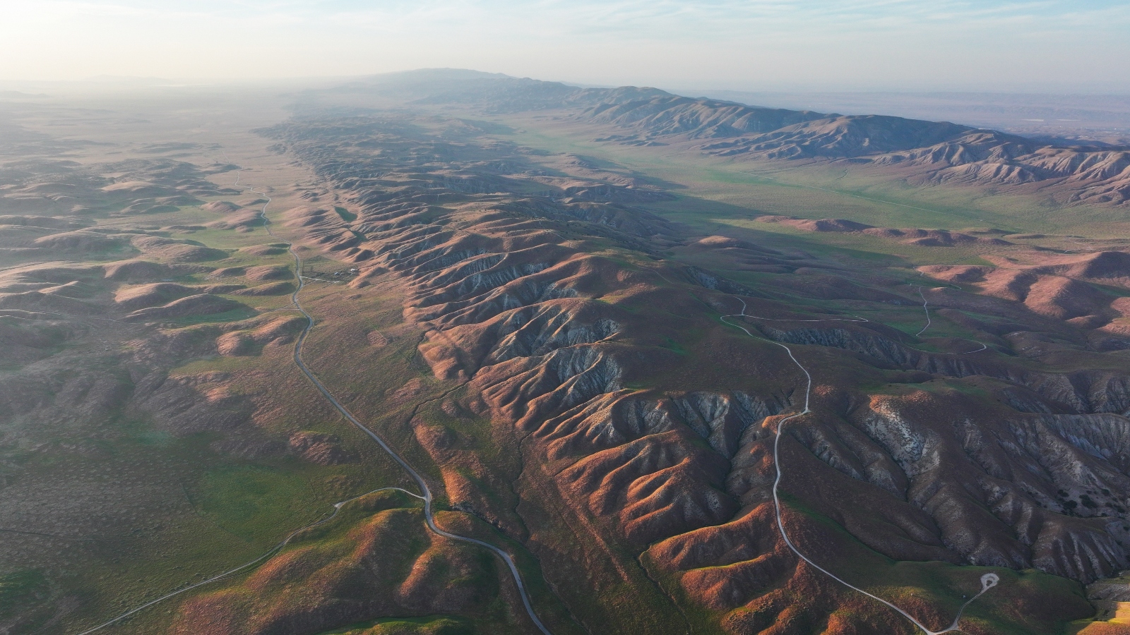 An aerial view of a brown and green mountain range
