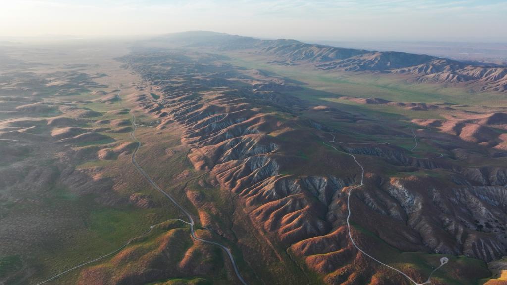 An aerial view of a brown and green mountain range