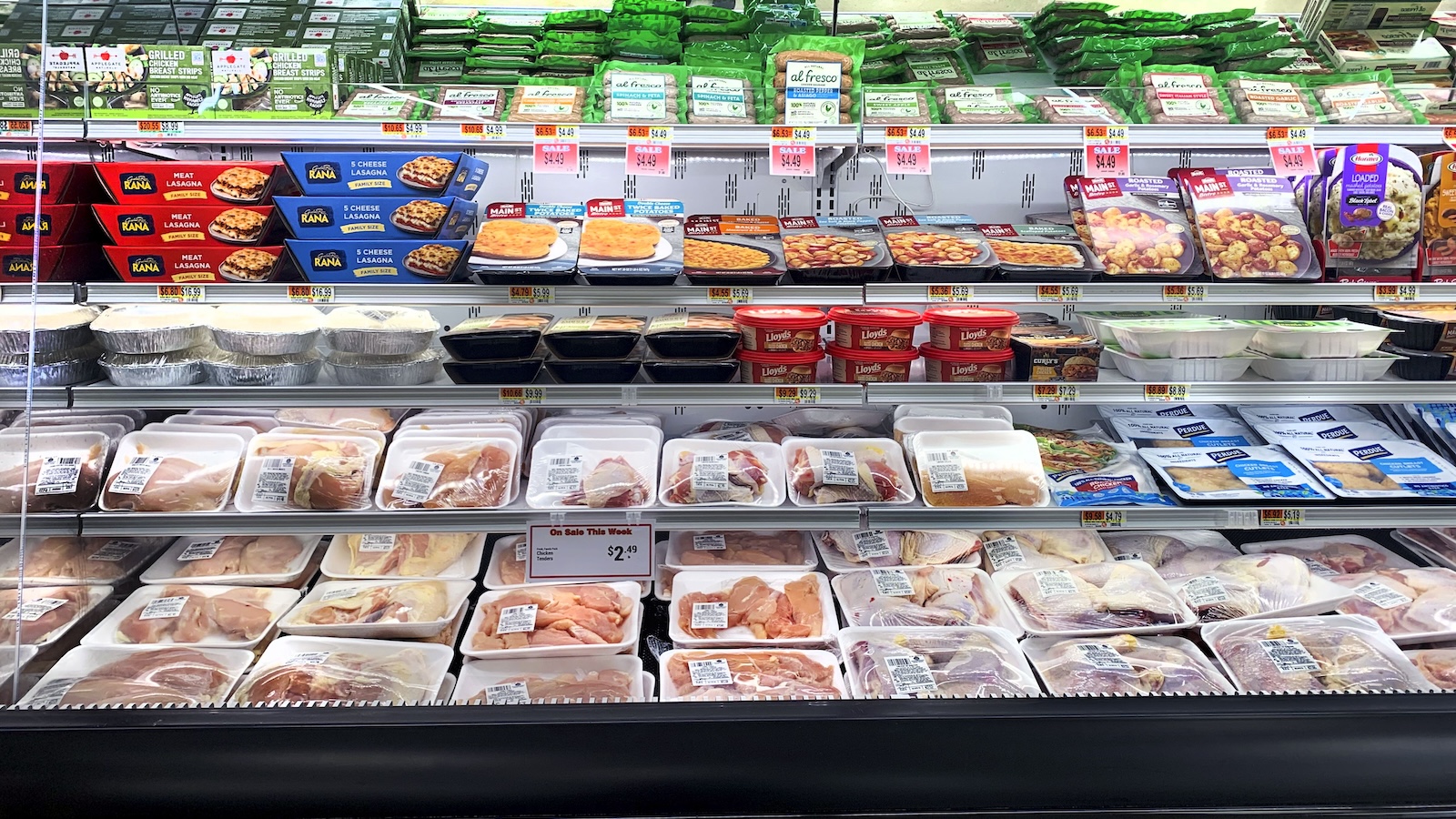 shot of packages of poultry on refrigerated grocery store shelves
