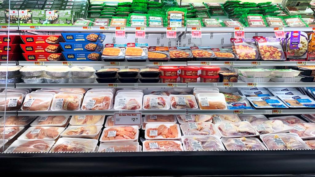 shot of packages of poultry on refrigerated grocery store shelves