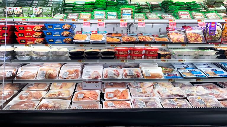 shot of packages of poultry on refrigerated grocery store shelves