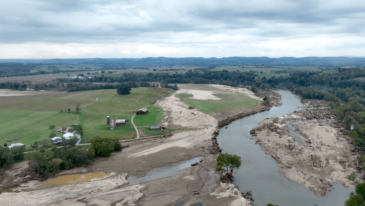 An aerial view of a farm along a river floodplain