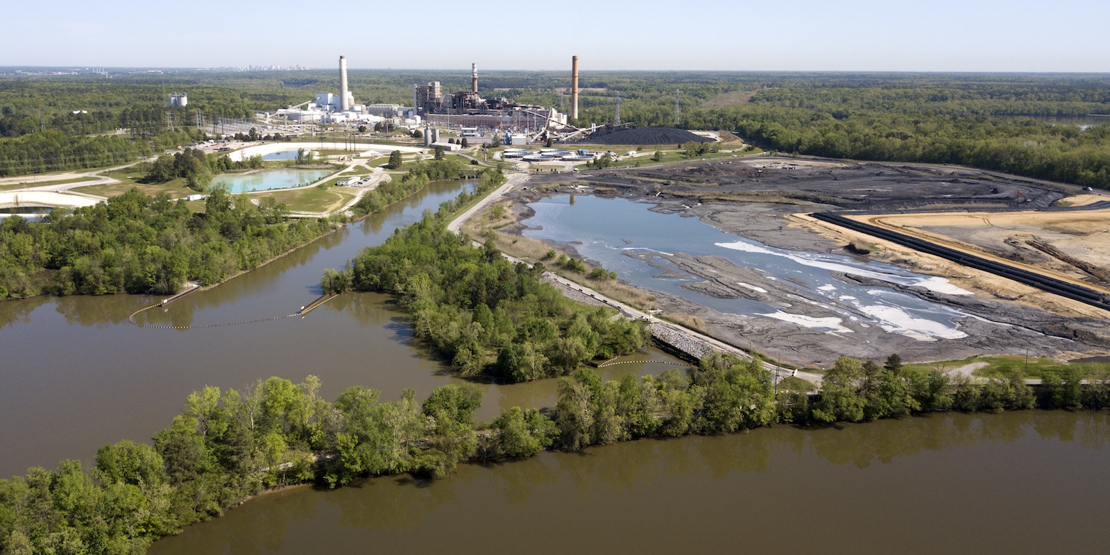 coal plant in the distance with lagoons in the foreground