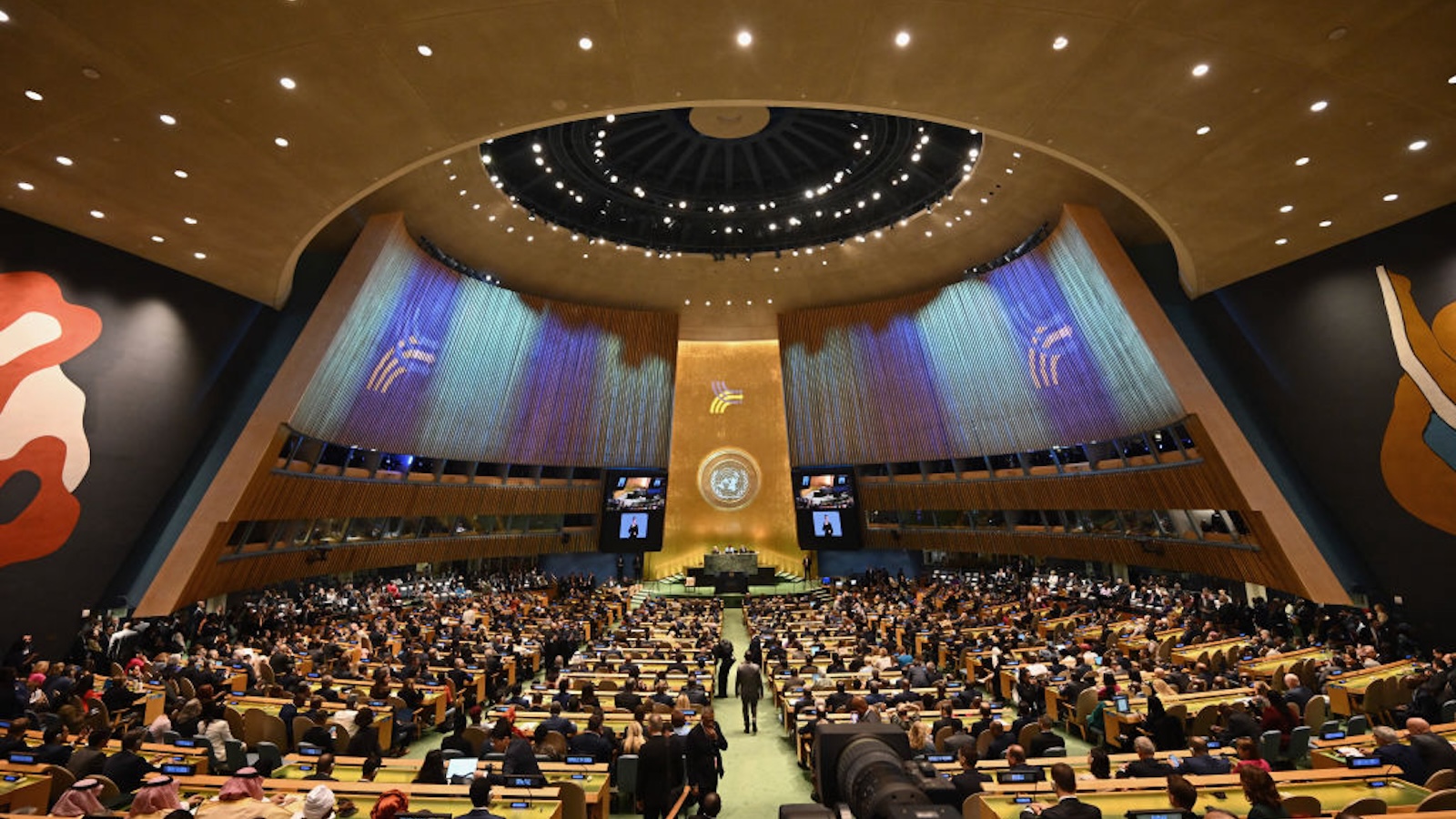 United Nations general assembly hall with hundreds of representatives seated