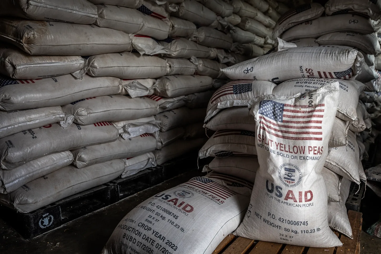 Sacks of the final batches of yellow peas delivered by the now-dismantled United States Agency for International Development (USAID) are stacked in a storage room