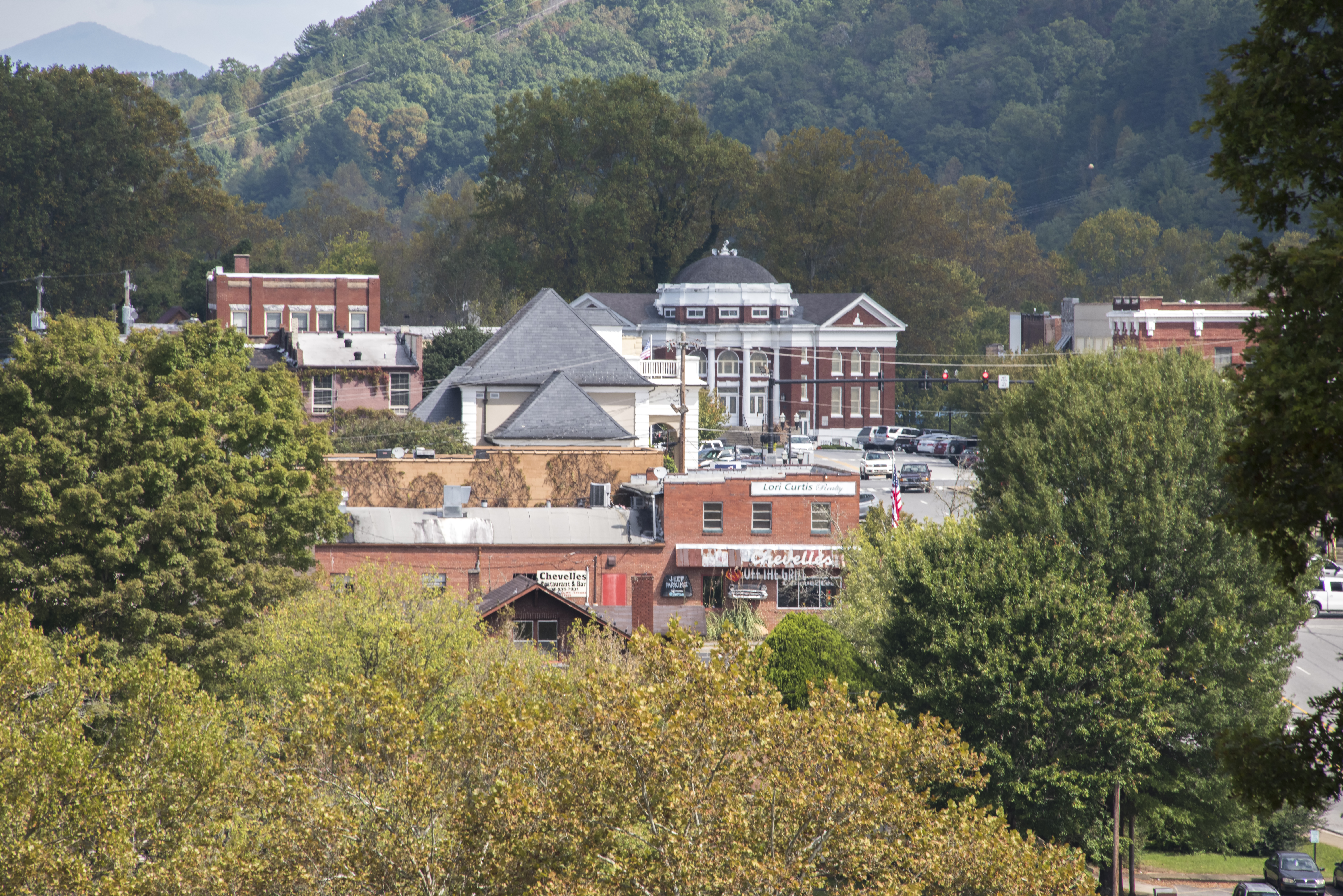The downtown of Murphy, a rural community in the mountains of North Carolina, is glimpsed through the trees.