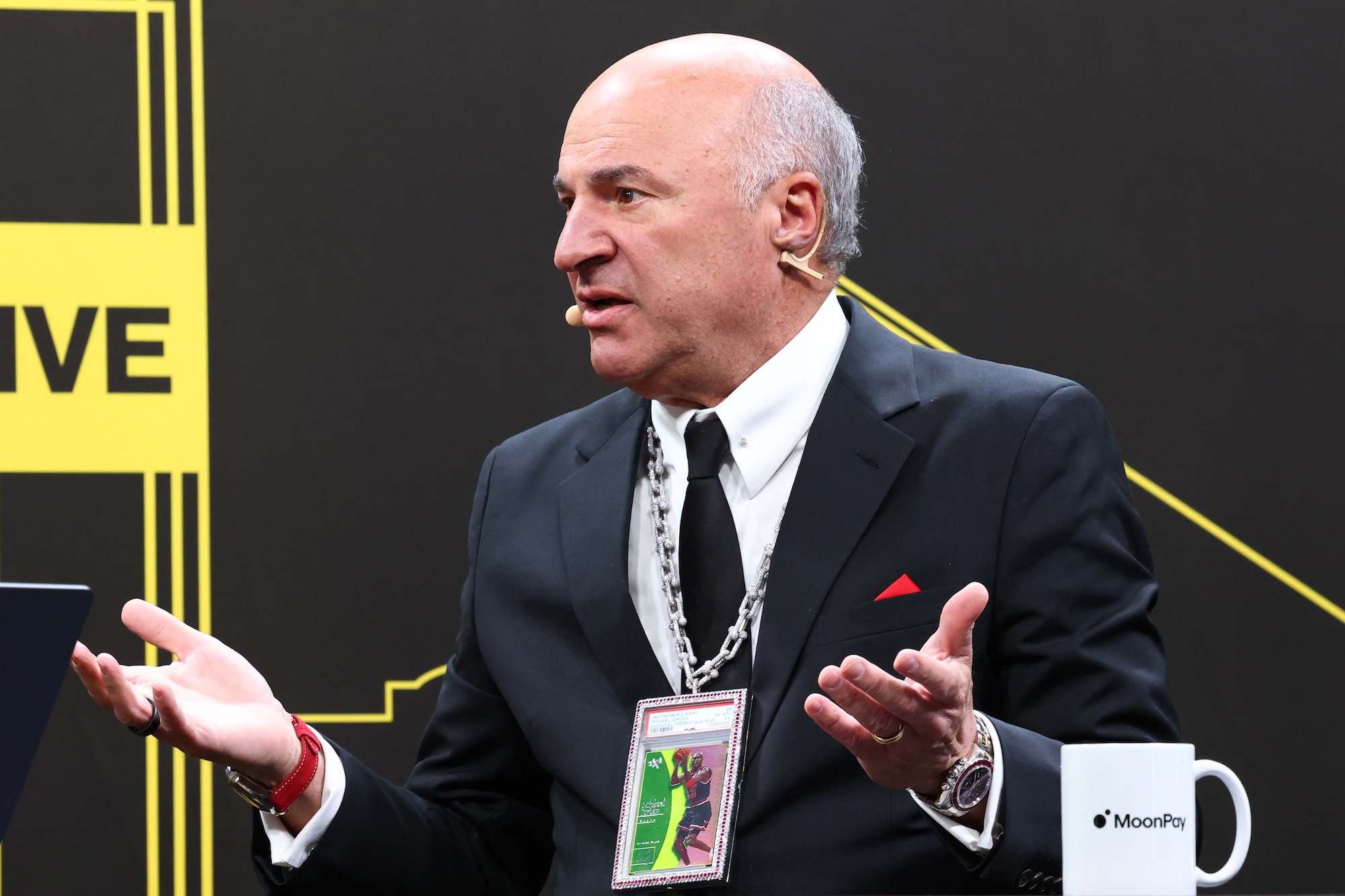 An investor, Kevin O'Leary, has both hands up while in conversation.