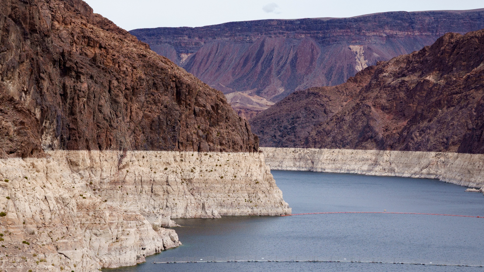 Water flows around brown and white rock formations