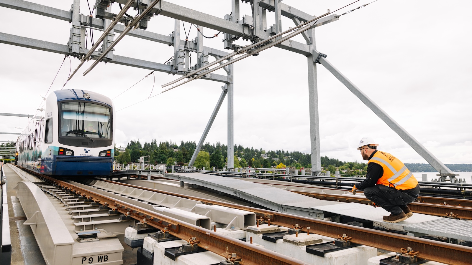 An unmanned light rail car s towed across a bridge to test a section of new track in Seattle.